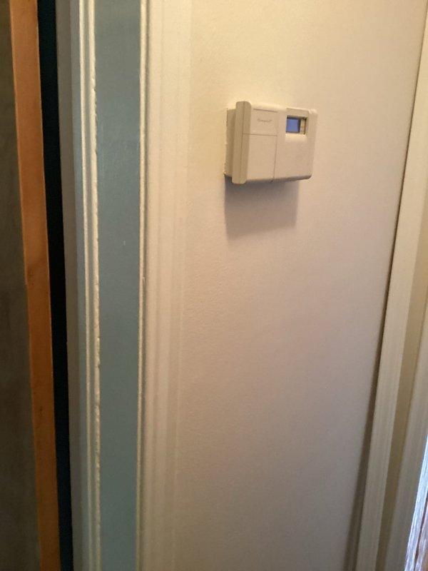Performed diagnostic evaluation on 22-year-old air conditioning system with reported cooling issues and damaged refrigerant line insulation. Upon inspection, confirmed system was low on R22 refrigerant and assessed overall condition of aging equipment. Documented thermostat operation and indoor furnace unit with associated ductwork and piping. Provided estimate for system replacement due to age of equipment, refrigerant type, and extent of repairs needed to restore proper operation.