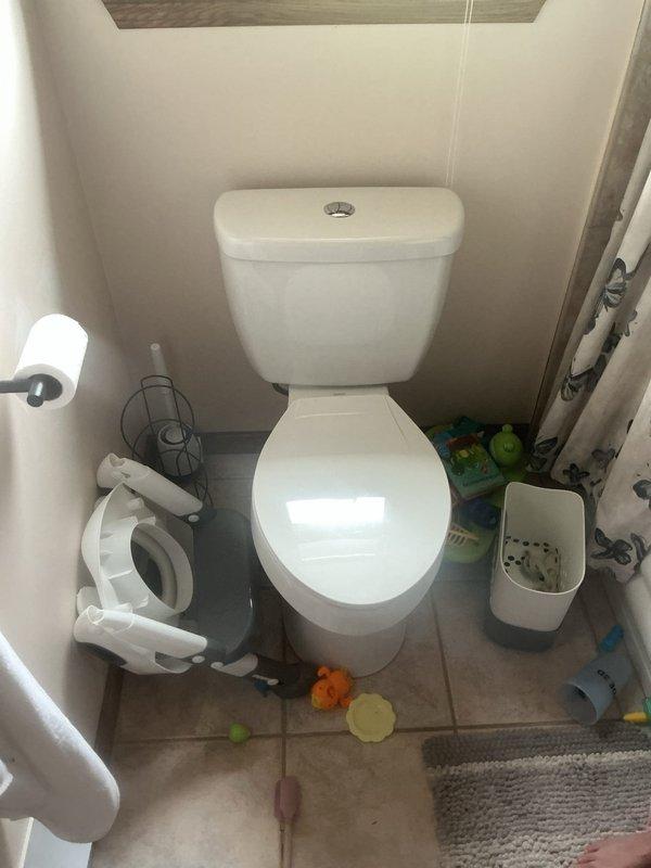 Responded to master bathroom toilet seal failure in 35-year-old residence where issue had persisted for over one week. Accessed plumbing system through ceiling cavity below fixture, inspecting PVC drainage lines, copper supply lines, and wax ring seal at floor flange. Replaced deteriorated wax ring seal and reinstalled toilet to manufacturer specifications, ensuring proper compression and watertight connection. Verified all connections for leaks, confirmed proper bowl operation, and documented pre-repair and post-access conditions with photographic evidence of work area and exposed plumbing infrastructure.