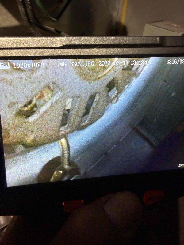 Responded to no cooling complaint on 10+ year old York cooling system located in basement. Upon inspection, discovered severe corrosion and deterioration of internal components, including metal fittings, pipes, and connections showing extensive oxidation, mineral deposits, and surface degradation. Thermostat malfunction attributed to system age and compromised components. Documented condition with inspection camera revealing advanced corrosion throughout affected areas. Advised customer of findings and recommended system replacement due to extent of deterioration and age of equipment.