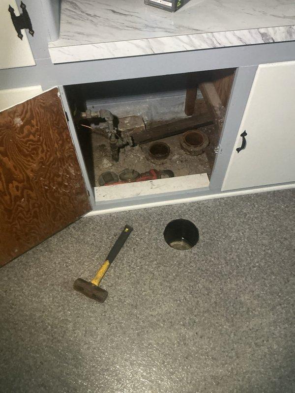 Responded to intermittent drainage backup in basement laundry room near washing machine. Accessed plumbing system through cabinet opening and inspected sump pump assembly with copper piping connections. Cleared obstruction from drain line, verified pump operation, and tested system to confirm proper water flow and drainage restored to normal function.