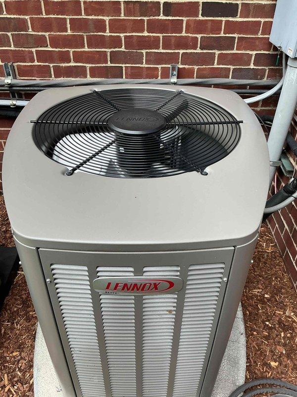 Completed comprehensive Gold AC inspection on multi-unit system including one-year-old Lennox air conditioning unit and four-year-old furnace with basement coil location. Performed full system diagnostics including combustion analysis readings showing oxygen levels at 9.7%, carbon monoxide at 61 PPM, and temperature readings at 75.1°F. Inspected outdoor condensing unit confirming proper operation, clean coils, secure refrigerant lines, and overall excellent equipment condition with no visible damage or excessive wear.