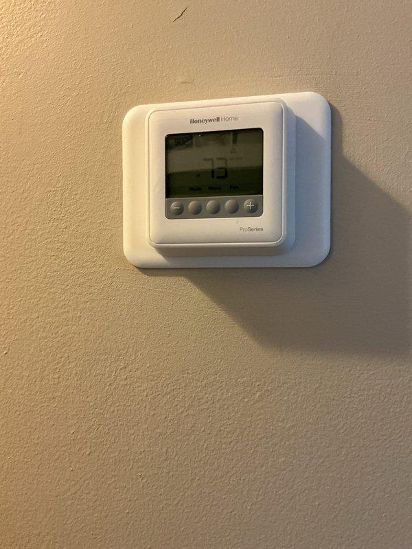 Completed Gold AC inspection on a 1-year-old system with outdoor condensing unit and basement air handler. Verified proper operation of all components, inspected Honeywell ProSeries thermostat functionality, examined outdoor unit condition including fan operation and coil cleanliness, and confirmed refrigerant lines and electrical connections were secure. System operating within normal parameters with no deficiencies noted.