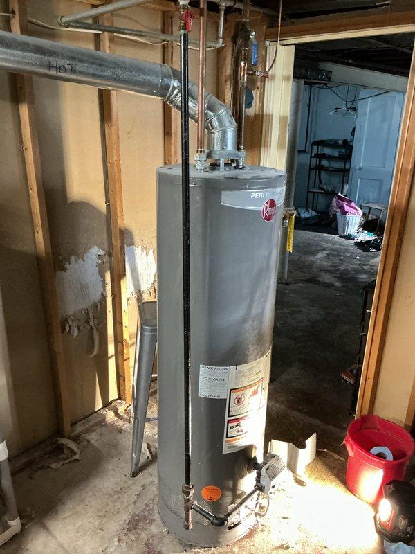 Responded to service call for Rheem Performance tanked water heater experiencing small leak and no hot water production. Upon inspection, identified water heater located in unfinished basement utility area with exposed plumbing connections and venting system. Evaluated unit's overall condition, plumbing connections including copper supply lines, galvanized vent piping, and pressure relief valve assembly. Assessed leak source and examined temperature/pressure relief valve, drain valve, and tank integrity. Documented water heater model specifications and installation configuration for replacement recommendations. Provided comprehensive evaluation and second opinion as requested regarding repair versus replacement options based on unit age and extent of failure.