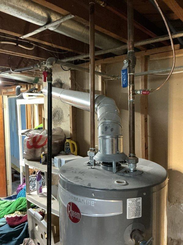 Responded to service call for Rheem Performance tanked water heater experiencing small leak and no hot water production. Upon inspection, identified water heater located in unfinished basement utility area with exposed plumbing connections and venting system. Evaluated unit's overall condition, plumbing connections including copper supply lines, galvanized vent piping, and pressure relief valve assembly. Assessed leak source and examined temperature/pressure relief valve, drain valve, and tank integrity. Documented water heater model specifications and installation configuration for replacement recommendations. Provided comprehensive evaluation and second opinion as requested regarding repair versus replacement options based on unit age and extent of failure.