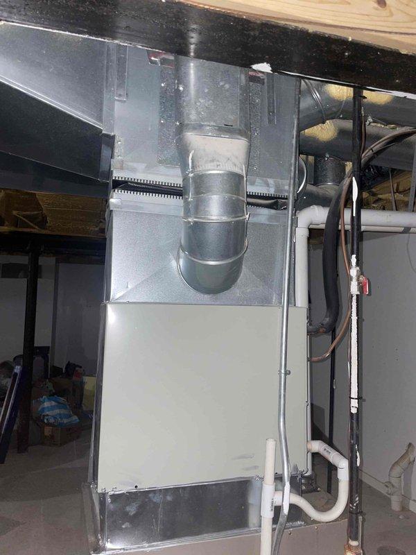 Conducted comprehensive site assessment for complete HVAC system replacement in basement installation. Evaluated existing 20+ year old unit, documented current equipment configuration including cabinet-style furnace and air handler with associated ductwork, refrigerant lines, and drainage systems. Photographed equipment specifications, energy ratings, and installation space constraints to provide accurate replacement estimate and equipment sizing recommendations.
