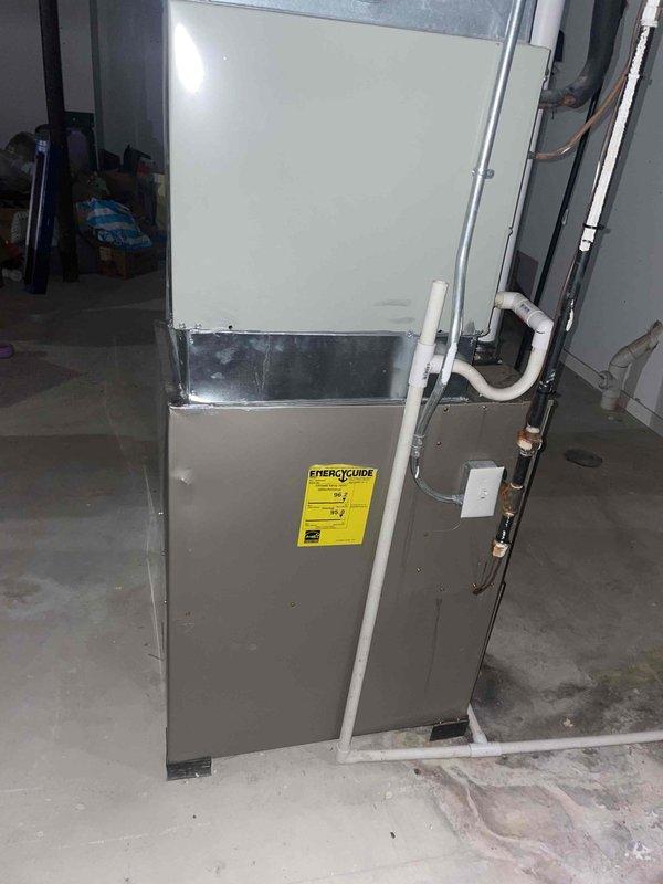 Conducted comprehensive site assessment for complete HVAC system replacement in basement installation. Evaluated existing 20+ year old unit, documented current equipment configuration including cabinet-style furnace and air handler with associated ductwork, refrigerant lines, and drainage systems. Photographed equipment specifications, energy ratings, and installation space constraints to provide accurate replacement estimate and equipment sizing recommendations.