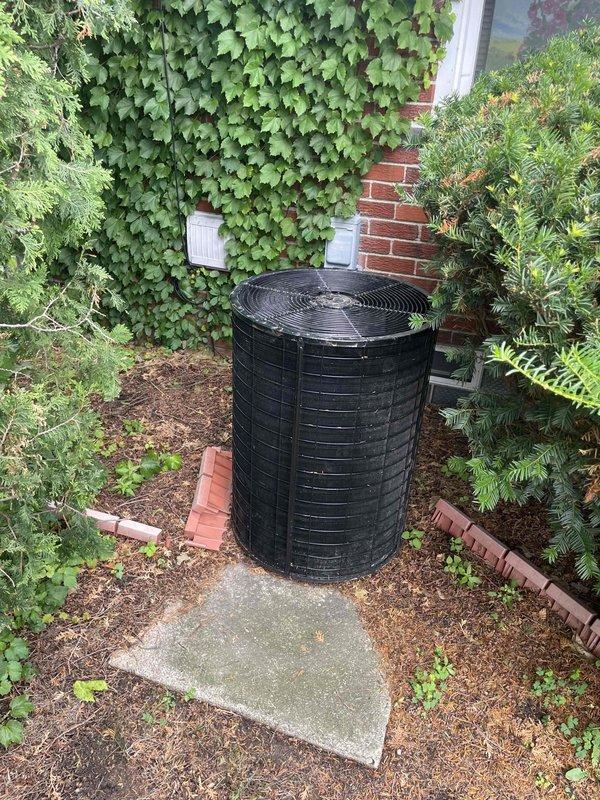 Responded to service call for residential air conditioning system not cooling while fan continued to operate. Inspected 25-year-old outdoor condensing unit located in backyard against brick wall foundation. Upon evaluation of the aged system and current operating conditions, provided comprehensive replacement estimate for new HVAC equipment. Documented existing unit configuration, electrical connections, and indoor air handler installation in garage for proper system sizing and replacement planning.