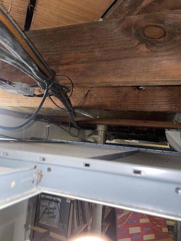 Responded to service call for residential air conditioning system not cooling while fan continued to operate. Inspected 25-year-old outdoor condensing unit located in backyard against brick wall foundation. Upon evaluation of the aged system and current operating conditions, provided comprehensive replacement estimate for new HVAC equipment. Documented existing unit configuration, electrical connections, and indoor air handler installation in garage for proper system sizing and replacement planning.