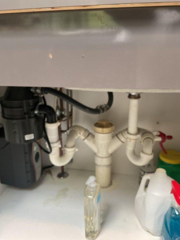 Responded to service call for major leak originating from recently installed garbage disposal unit. Upon inspection, identified leak at disposal discharge connection to drain assembly. Tightened discharge elbow connection and verified proper alignment of PVC drain piping. Tested system by running water and operating disposal unit to confirm leak was resolved and all connections remained secure and dry.