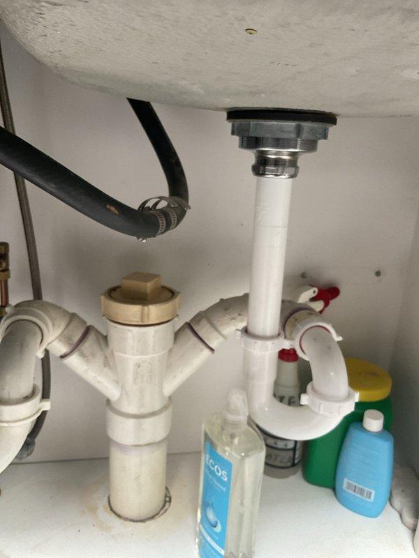 Responded to service call for major leak originating from recently installed garbage disposal unit. Upon inspection, identified leak at disposal discharge connection to drain assembly. Tightened discharge elbow connection and verified proper alignment of PVC drain piping. Tested system by running water and operating disposal unit to confirm leak was resolved and all connections remained secure and dry.