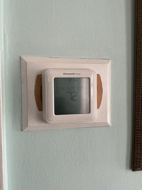 Responded to service call for 5-year-old AC system running but not cooling properly. Upon arrival, verified thermostat was calling for cooling and set to 72°F. Inspected Bryant furnace and air handler in basement mechanical room, confirming indoor blower operation and proper airflow through ductwork. Proceeded to exterior condensing unit to diagnose cooling failure. Found compressor not engaging due to failed start capacitor. Replaced defective capacitor with OEM equivalent, tested compressor operation, and verified proper amperage draw. Checked refrigerant pressures on both high and low sides, confirming adequate charge levels. System restored to full cooling capacity with temperature differential within manufacturer specifications. Documented equipment conditions with photos of thermostat and indoor HVAC components for service records.