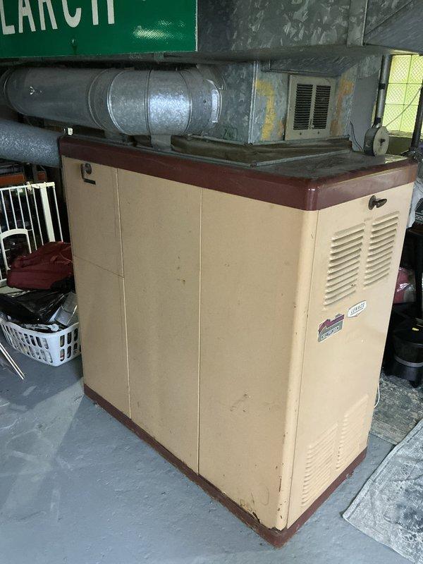 Conducted comprehensive site assessment for full HVAC system replacement in residential property. Evaluated existing aging furnace unit and ductwork infrastructure currently installed in basement mechanical room. Documented current system configuration including beige cabinet-style furnace with visible wear, discoloration, and outdated components. Assessed galvanized metal ductwork showing significant rust staining, corrosion, and age-related deterioration throughout distribution system. Photographed equipment layout, plenum connections, and surrounding mechanical space to develop accurate replacement specifications. Evaluated structural constraints, clearances, and accessibility for new furnace installation and addition of central air conditioning system. Identified necessary modifications to existing duct system to accommodate AC integration. Provided detailed estimate for complete system replacement including new high-efficiency furnace, central air conditioning unit, and any requir