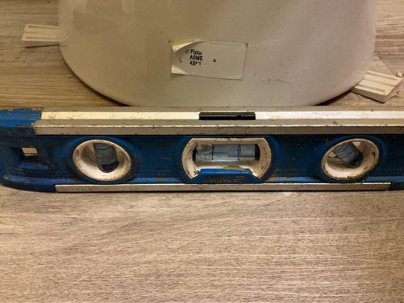 Responded to service call for unstable toilet with deteriorating wax seal at base. Upon inspection, confirmed toilet was shifting due to failed seal and improper securing to floor flange. Removed toilet from mounting bolts, scraped away old wax ring residue, and inspected flange condition. Verified flange integrity and levelness using precision measuring tools. Installed new wax ring seal, repositioned toilet onto flange, and secured unit with new closet bolts torqued to proper specifications. Tested toilet stability and verified level installation to prevent future movement and potential water damage.