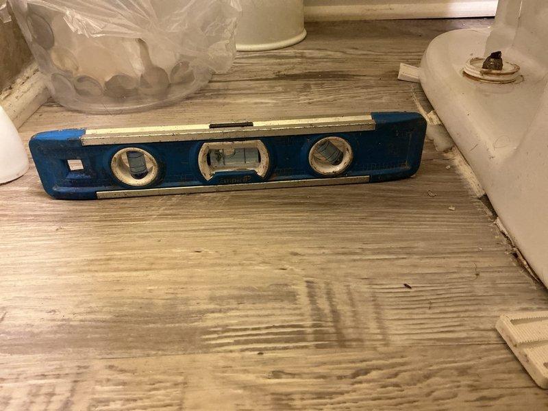 Responded to service call for unstable toilet with deteriorating wax seal at base. Upon inspection, confirmed toilet was shifting due to failed seal and improper securing to floor flange. Removed toilet from mounting bolts, scraped away old wax ring residue, and inspected flange condition. Verified flange integrity and levelness using precision measuring tools. Installed new wax ring seal, repositioned toilet onto flange, and secured unit with new closet bolts torqued to proper specifications. Tested toilet stability and verified level installation to prevent future movement and potential water damage.