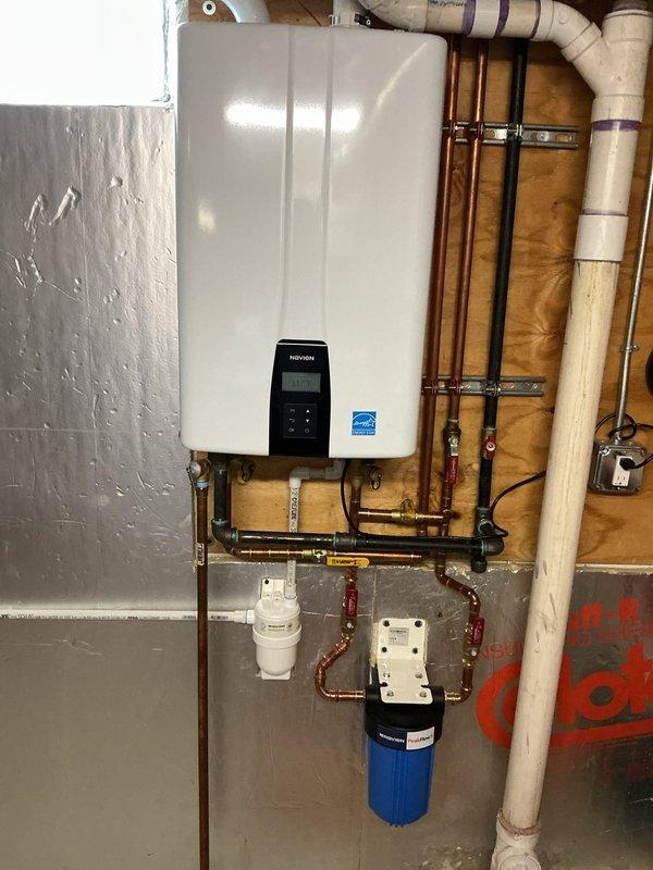 Performed annual maintenance flush on one-year-old Navien tankless water heater unit. Isolated unit using service valves, connected flushing pump with descaling solution to inlet and outlet ports, and circulated cleaning agent through heat exchanger for recommended duration to remove mineral buildup and scale deposits. Inspected all copper supply and return lines, verified proper operation of isolation valves, and checked inlet filter screen for debris. Confirmed digital control panel displayed normal operating parameters, tested pressure relief valve operation, and verified adequate venting. Reconnected water supply, purged air from system, and conducted operational test to ensure proper hot water delivery and unit functionality. System restored to full service with all components operating within manufacturer specifications.