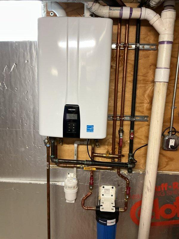 Performed annual maintenance flush on one-year-old Navien tankless water heater unit. Isolated unit using service valves, connected flushing pump with descaling solution to inlet and outlet ports, and circulated cleaning agent through heat exchanger for recommended duration to remove mineral buildup and scale deposits. Inspected all copper supply and return lines, verified proper operation of isolation valves, and checked inlet filter screen for debris. Confirmed digital control panel displayed normal operating parameters, tested pressure relief valve operation, and verified adequate venting. Reconnected water supply, purged air from system, and conducted operational test to ensure proper hot water delivery and unit functionality. System restored to full service with all components operating within manufacturer specifications.
