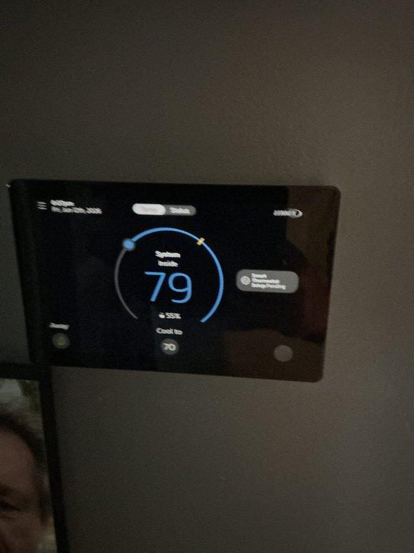 Completed full HVAC system installation including a 70,000 BTU furnace rotated 90 degrees for proper fit, 2.5 ton air conditioning unit positioned in rear yard, chimney liner, and digital programmable thermostat. Installed S40 filter system with 4x25 media filter, reconnected gas and electrical connections, and set up condensate pump. Permit was requested and system tested successfully with thermostat cooling to target temperature of 70 degrees.