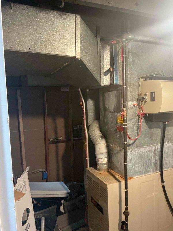 Completed AC tune-up on basement-located system with customer complaint of inadequate cooling. Performed comprehensive inspection revealing significant condensation accumulation on ductwork and dust buildup on unit components, indicating potential airflow restrictions and drainage concerns. Cleaned accessible components, verified system operation, and addressed moisture issues to restore proper cooling function.