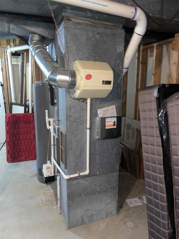 Completed routine AC tune-up maintenance on basement air conditioning system of unknown age with no reported issues. Performed standard preventive maintenance procedures including inspection of ductwork, refrigerant lines, electrical connections, and associated HVAC components. System found in operational condition with typical dust accumulation on ductwork and surrounding equipment consistent with normal use.