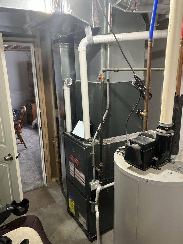 Provided estimate for complete furnace and air conditioning system replacement in basement installation. Existing 10+ year old natural gas heating and cooling equipment is non-operational and requires full system replacement. Assessment included evaluation of current electrical infrastructure, venting configuration with existing PVC exhaust system, and available space for new equipment installation adjacent to water heater and electrical panel.