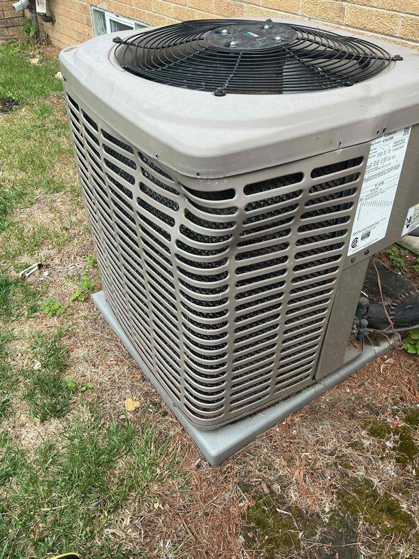Responded to service call for air conditioning system reported to be low on refrigerant. Inspected Lennox HVAC system with equipment located in basement and outdoor condenser unit positioned on concrete pad adjacent to building exterior. Performed system diagnostics including pressure testing, leak detection, and operational assessment of the 2017 model unit to determine refrigerant levels and identify any potential leaks in the system.