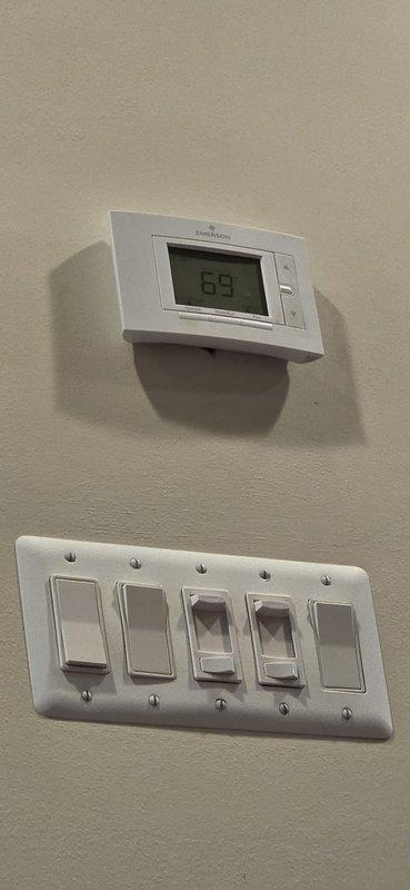 Successfully completed installation of 110,000 BTU furnace system in front yard location with full mechanical permit compliance. Installation package included furnace base, dual Emerson Sensi thermostats (visible in photo showing wall-mounted digital display reading 69°), 600 CFM humidifier, and high-velocity air delivery system. Reconnected all existing utilities and verified proper system operation, with homeowner qualified for utility company energy efficiency rebate program.