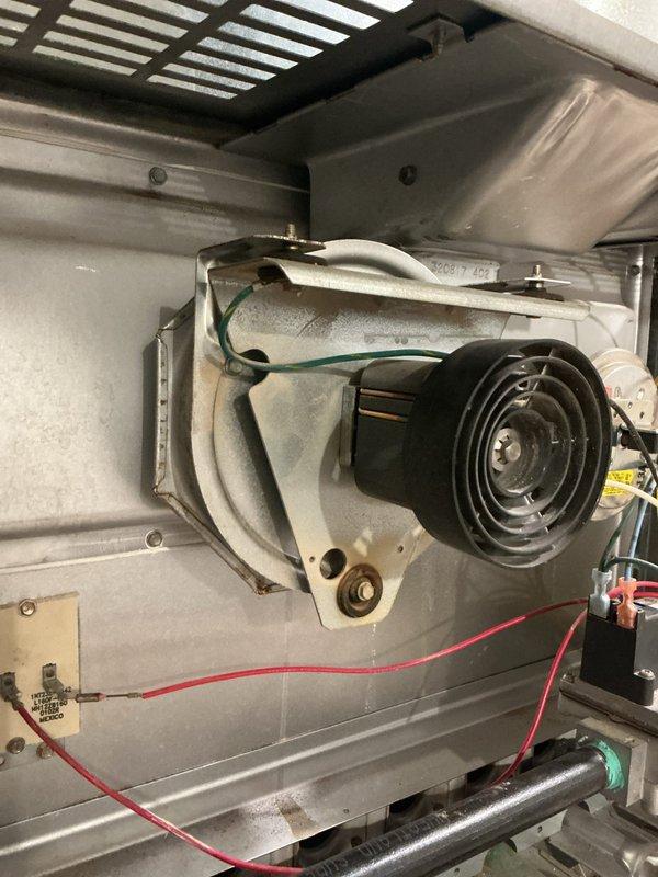 Responded to service call for loud rattling noise coming from 20-year-old furnace located in basement. Upon inspection, identified blower motor assembly as source of noise due to worn bearings and accumulated debris causing imbalance. Removed blower motor assembly from unit, cleaned housing and ductwork connections, and inspected electrical connections and wiring for proper function. Reinstalled blower assembly and tested system operation to verify noise elimination and proper airflow.