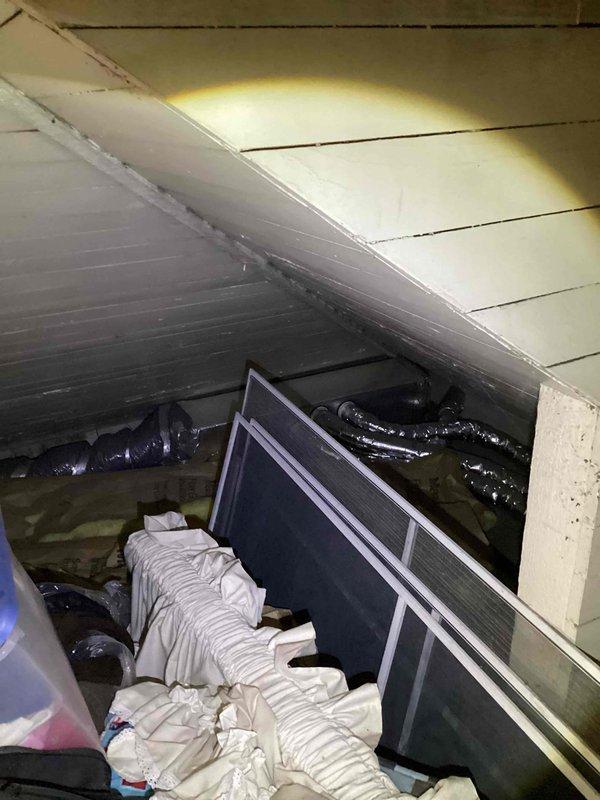 Provided comprehensive estimate for complete ductwork replacement serving upstairs natural gas furnace system. Assessed existing deteriorated ductwork installation in basement and attic spaces, noting compromised metallic ductwork with inadequate insulation and inefficient routing through confined crawl space. Evaluated current HVAC air handler unit located in attic area with black flexible ductwork requiring replacement due to age and performance concerns. Documented extensive ductwork layout including vertical chase runs, horizontal distribution systems, and connection points to existing gas furnace equipment. Recommended full ductwork system redesign to improve airflow efficiency, reduce energy loss, and enhance overall HVAC system performance throughout home.