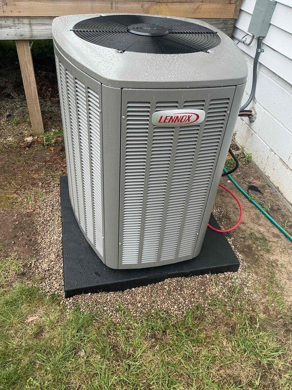 Completed full installation of a 3.5-ton Lennox air conditioning system with uncased evaporator coil at rear of property. Unit was properly positioned on rubber pad, electrical disconnect installed and wired per code, refrigerant lines connected and system commissioned to manufacturer specifications. Permit documentation initiated and system tested for proper operation with all components functioning as designed.