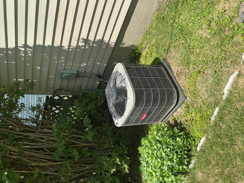 Responded to service call for squeaking noise from outdoor air conditioning condenser unit. Upon arrival, inspected 13-year-old AC system and performed diagnostic assessment of outdoor unit components. Conducted visual inspection of condenser unit, examining fan motor, bearings, and mechanical components to identify source of squeaking noise. Evaluated system operation and confirmed cooling performance remained unaffected. Documented equipment condition with photographs of outdoor condenser unit and related HVAC infrastructure. Unit found to be operating with adequate cooling capacity despite audible noise concern.