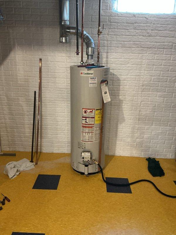 Responded to emergency service call for water heater leaking after recent installation. Upon arrival, inspected Lochinvar tanked water heater unit and associated plumbing connections. Identified leak source at copper piping connections at top of unit. Tightened fittings, checked pressure relief valve operation, and verified expansion tank mounting and pressure. Tested all connections for leaks, confirmed proper water flow, and ensured system was operating within manufacturer specifications. Cleaned work area and removed excess water from floor using protective materials.