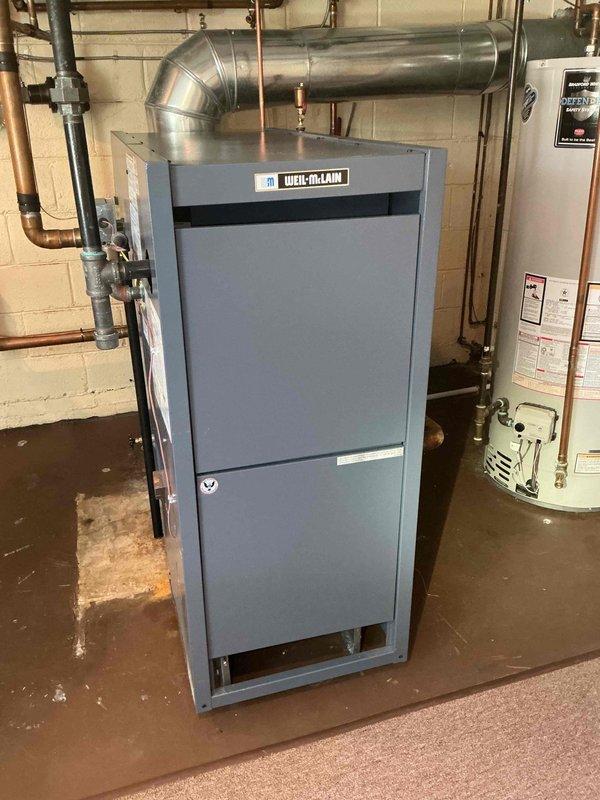 Completed comprehensive Gold AC inspection on 1-year-old Mitsubishi Electric mini-split system with outdoor condenser unit mounted on exterior brick wall and air handler located in basement. Performed thorough multi-point inspection including refrigerant line examination, electrical connection verification, condensate drain check, and operational testing of both indoor and outdoor units. System found to be operating within manufacturer specifications with all components functioning properly and no deficiencies noted.