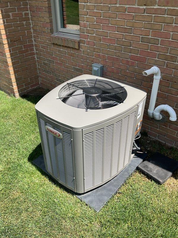 Completed comprehensive Gold AC inspection on 2-year-old Lennox outdoor condensing unit and associated basement air handler system. Performed full system evaluation including visual inspection of condenser unit mounted on concrete pad, verified proper refrigerant line connections via exterior PVC piping, checked electrical disconnect, and assessed overall equipment operation. Inspected basement mechanical components including water heater plumbing connections and HVAC system interfaces. All equipment found to be in proper working condition with no deficiencies noted during inspection.