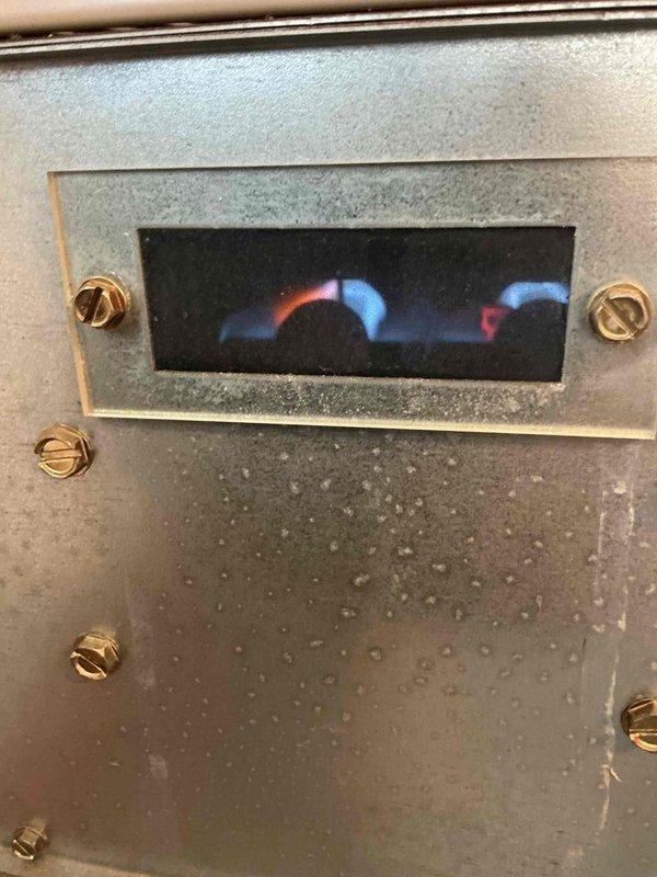 Completed comprehensive furnace inspection and tune-up on 15-20 year old unit located in downstairs corner of building. Performed full system diagnostics, verified proper burner ignition and flame pattern showing characteristic blue flames with proper combustion, inspected blower motor assembly and electrical connections, checked all safety controls and limit switches, and confirmed adequate airflow through system. All components found operating within manufacturer specifications with no immediate repairs required at this time.