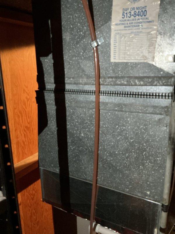 Responded to call regarding AC line freezing on operational cooling system. Upon arrival, confirmed R22 refrigerant system with low charge condition. Inspected outdoor condensing unit and indoor furnace/air handler located in basement. Documented existing HVAC equipment of unknown age with copper refrigerant lines showing signs of ice formation. Diagnosed low refrigerant charge as primary cause of freezing condition. Provided estimate for system replacement due to R22 refrigerant phase-out and age-related concerns of existing equipment.