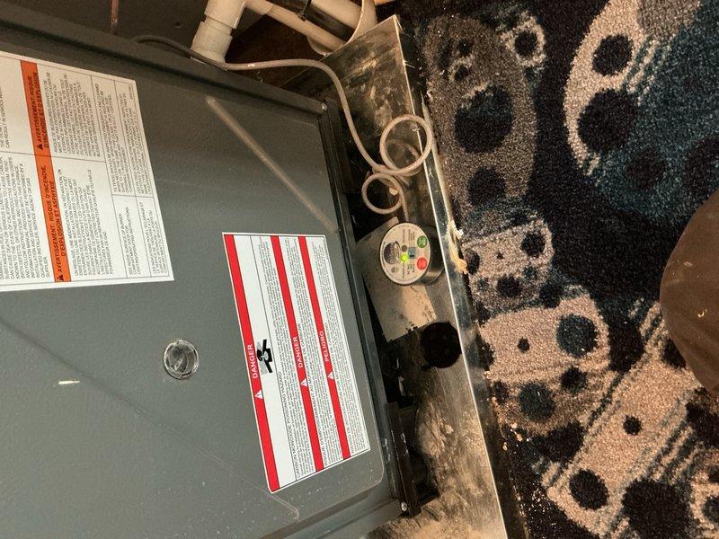 Responded to service call for 9-year-old furnace unit located in movie room with reported leak and operational failure. Upon arrival, conducted thorough visual inspection of air handler system, condensate drainage lines, and associated PVC piping. Identified leak source in condensate drain system and assessed overall unit functionality. Inspected electrical connections, control panel wiring, and safety labels for compliance. Examined ductwork insulation, copper refrigerant lines, and blower assembly for signs of damage or deterioration. Documented equipment condition through photographic evidence showing unit installation, drainage configuration, and mechanical components. Provided homeowner with findings and recommended next steps for repair to restore proper heating operation.