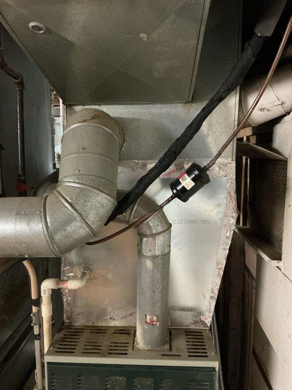 Conducted comprehensive evaluation of 10+ year old furnace system located in basement for pre-sale city certification and gas leak assessment. Inspected furnace cabinet, heat exchanger, burner assembly, gas valve, and all supply connections to identify source of reported gas leak. Examined ductwork connections, ventilation components, and overall system integrity. Documented equipment condition with detailed photographs showing furnace unit, ductwork configuration, and mechanical components. Provided estimate for necessary repairs to address gas leak and bring system into compliance with municipal safety standards required for property transfer certification.