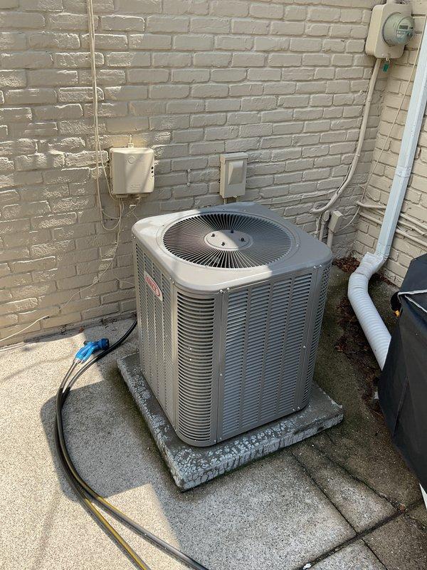 Completed comprehensive Gold AC inspection on 5-year-old residential HVAC system with air handler located in attic and outdoor condensing unit. Performed thorough evaluation of outdoor condenser unit including inspection of refrigerant lines, electrical connections, and condensate drainage system. Assessed attic-mounted air handler and associated ductwork, including inspection of humidifier control system and verification of proper humidity settings and operational parameters. Documented equipment condition through photographic records showing condenser unit on concrete pad with proper clearances, refrigerant line connections, and PVC drainage piping. Verified all components functioning within normal operating parameters for system age and confirmed unit operational status with homeowner present during inspection.