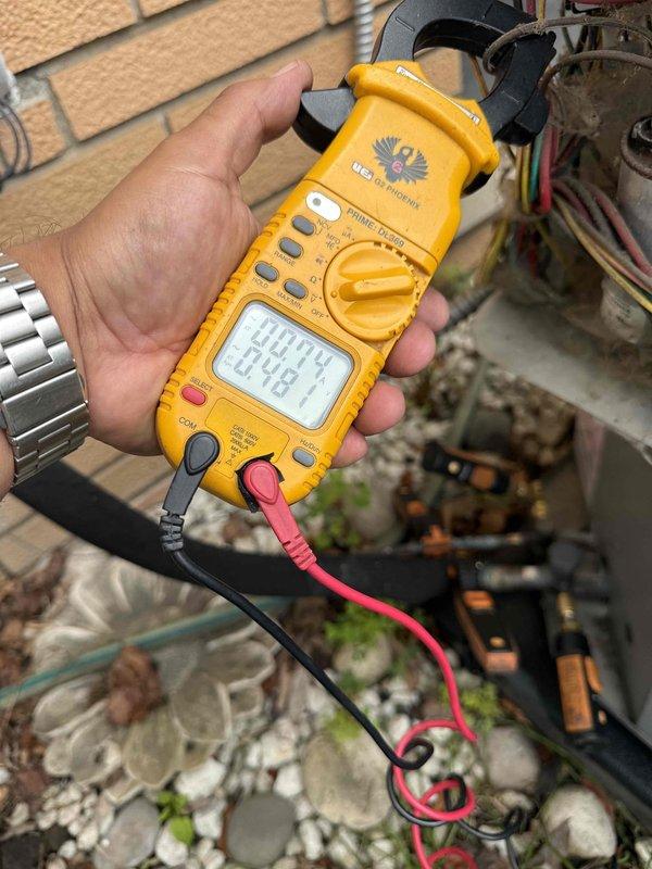 Responded to no airflow complaint on 10-year-old split system with ice buildup on suction line. Found condenser and air handler operating but system experiencing refrigerant freeze-up at multiple points along insulated refrigerant piping. Performed diagnostic testing using digital multimeter to check electrical components and capacitor operation at outdoor condensing unit. System likely experiencing low refrigerant charge or restricted airflow causing evaporator coil to ice over, resulting in blocked air distribution through vents.