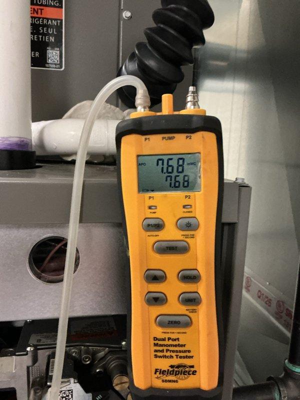 Completed full HVAC system installation including new furnace and air conditioning unit in basement utility area. Installed Ecobee 3 Lite smart thermostat for system control and programming. Ran new PVC condensate drain lines and venting, connecting to existing infrastructure with proper pitch and support. Performed pressure switch testing using digital manometer, verifying proper system pressures at 76.8 reading on both ports to ensure safe operation. Connected new ductwork with insulated trunk lines and flexible transitions. Secured all electrical connections and verified proper voltage supply. Submitted permit application and utility rebate paperwork for processing. System startup completed with all safety checks passed and equipment operating within manufacturer specifications.