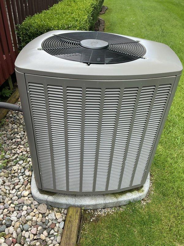 Completed comprehensive Gold AC inspection on 2023 residential air conditioning system. Inspected outdoor condenser unit, verified proper installation on concrete pad with adequate clearance and landscaping, confirmed unit operational status and exterior condition showing no visible damage or wear. Evaluated air handler/coil location and system components, documented equipment with photographic records per maintenance protocol.