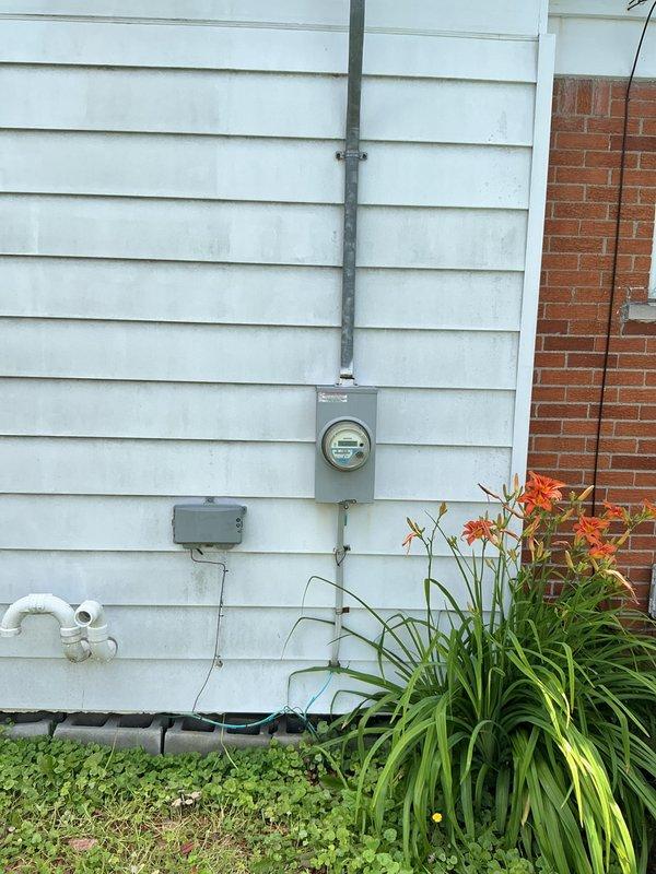 Conducted on-site evaluation for generator transfer switch installation at residential property. Customer currently operates portable generator with extension cords and requested estimate for permanent transfer switch solution. Assessed existing electrical service panel location, meter base configuration, and optimal routing path for generator inlet connection. Documented current electrical infrastructure including exterior conduit runs, service entrance equipment, and available mounting locations for transfer switch and generator inlet box. Evaluated wire path requirements from proposed transfer switch location to exterior generator connection point, accounting for building penetrations and code-compliant installation methods. Photographed existing electrical service equipment and exterior wall conditions to determine material requirements and labor scope for complete installation.