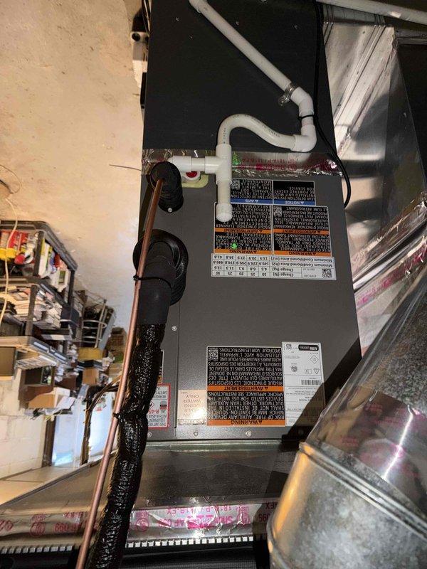 Responded to complaint of AC not cooling well in basement location. Upon arrival, accessed air handler unit installed in attic space. Performed comprehensive system diagnostics using digital measurement tools to assess air side performance. Measured return air conditions showing dry bulb temperature of 62.5°F, wet bulb of 55.1°F, with relative humidity at 62.3% and dew point of 49.5°F. Supply air readings indicated dry bulb temperature of 44.7°F, wet bulb of 42.3°F, with relative humidity at 82.2% and dew point of 39.6°F. Confirmed temperature split of 17.8°F across the evaporator coil, which falls within acceptable operating parameters for proper cooling performance. Inspected air handler unit, PVC condensate drain line, and associated ductwork connections. Documented system conditions with photos showing unit installation and measurement data. System operating properly with adequate cooling capacity and airflow at time of service.