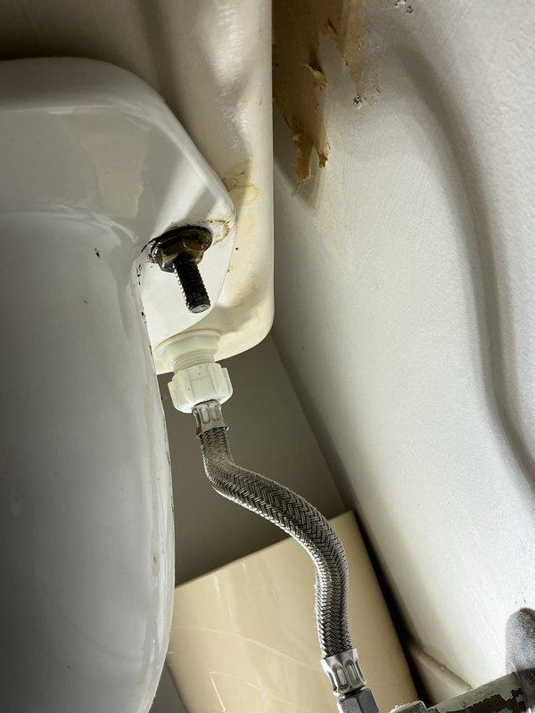 Completed toilet installation to address active leak at fixture base. Removed existing toilet, inspected flange and wax ring, and installed new toilet with proper sealing to prevent future water intrusion. Connected braided stainless steel flexible supply line to fill valve with secure fittings. Water damage evident on surrounding wall surfaces indicated previous long-term leakage from failed seal, which has been corrected with new installation.