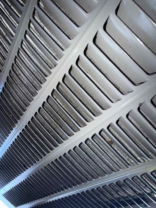 Completed comprehensive Gold AC Tune-Up on backyard air conditioning unit of unknown age. Performed thorough inspection of condenser coils, which showed varying levels of dust accumulation with heavy buildup noted on portions of the heat exchanger fins requiring attention. Utilized digital multimeter to verify electrical readings and system performance, confirming proper voltage and amperage levels throughout the unit. Cleaned condenser coils to restore optimal airflow and heat transfer efficiency. Inspected all electrical connections, refrigerant lines, and mechanical components for wear or damage. System operating within normal parameters following service completion.