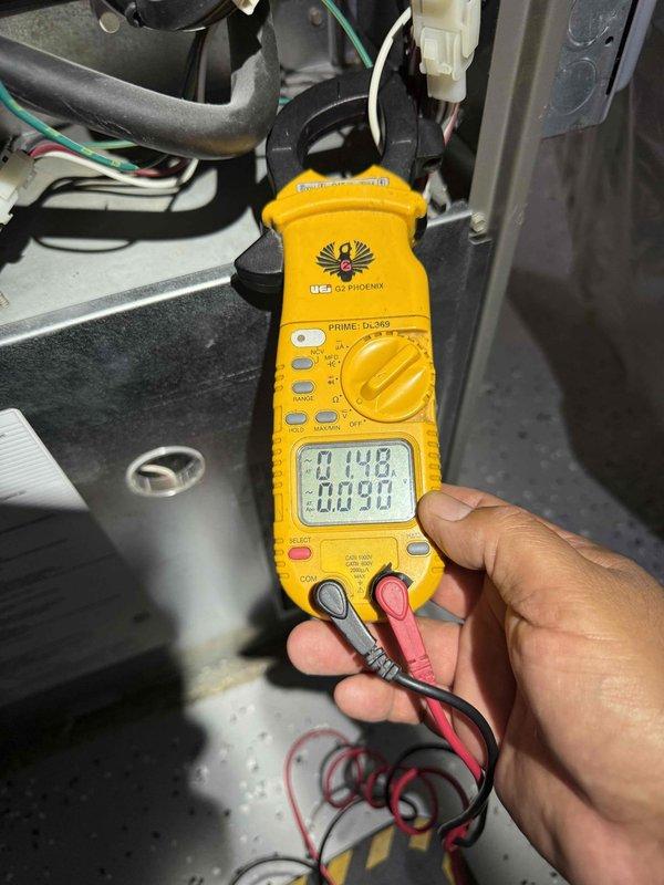 Completed comprehensive Gold AC Tune-Up on backyard air conditioning unit of unknown age. Performed thorough inspection of condenser coils, which showed varying levels of dust accumulation with heavy buildup noted on portions of the heat exchanger fins requiring attention. Utilized digital multimeter to verify electrical readings and system performance, confirming proper voltage and amperage levels throughout the unit. Cleaned condenser coils to restore optimal airflow and heat transfer efficiency. Inspected all electrical connections, refrigerant lines, and mechanical components for wear or damage. System operating within normal parameters following service completion.