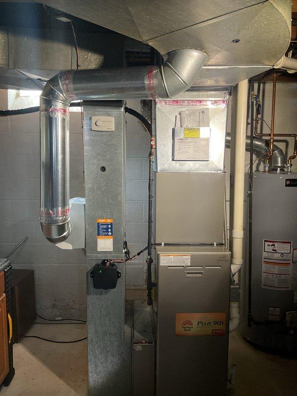 Successfully installed a complete 2-ton air conditioning system with matching evaporator coil in basement mechanical room. Installation included new outdoor condensing unit positioned at rear of property, indoor coil mounted to existing Plus 90b furnace, and all necessary refrigerant line sets with proper insulation. Reconnected humidifier to new system and verified proper integration with existing ductwork. All mechanical and electrical permits obtained and work completed to code specifications.