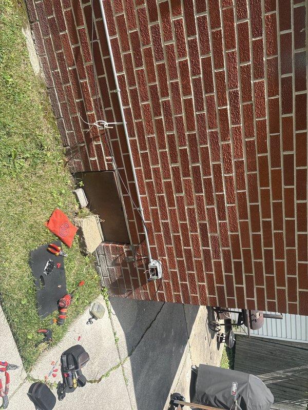 Responded to service call for malfunctioning exterior light fixture mounted on brick wall. Upon inspection, found weathered electrical junction box with exposed and improperly terminated wiring, including disconnected ground, neutral, and hot conductors. Assessed fixture and electrical box condition, documented existing wiring configuration and code compliance issues. Provided recommendations for fixture replacement and proper electrical connection repair to restore safe operation of exterior lighting system.