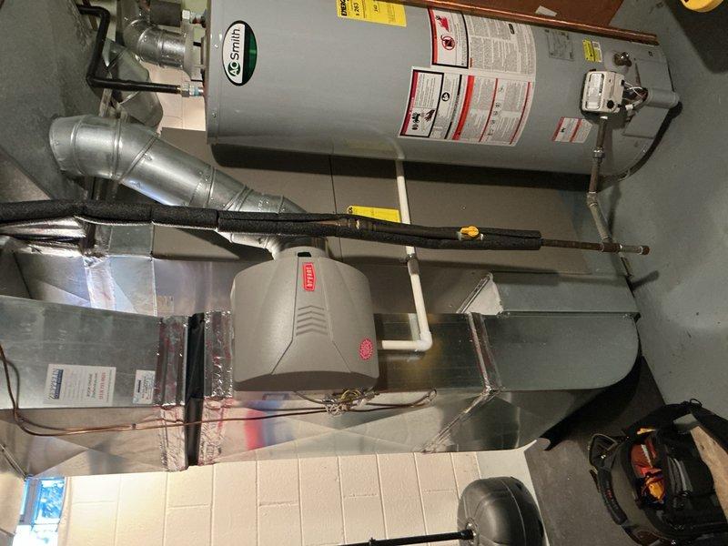 Completed comprehensive Gold AC inspection on 2017 HVAC system located in basement. Performed full system evaluation including inspection of air handler, ductwork, humidifier unit, refrigerant lines with insulation, and associated components. All equipment found operating properly with no immediate service needs identified; documentation photos captured for maintenance records.