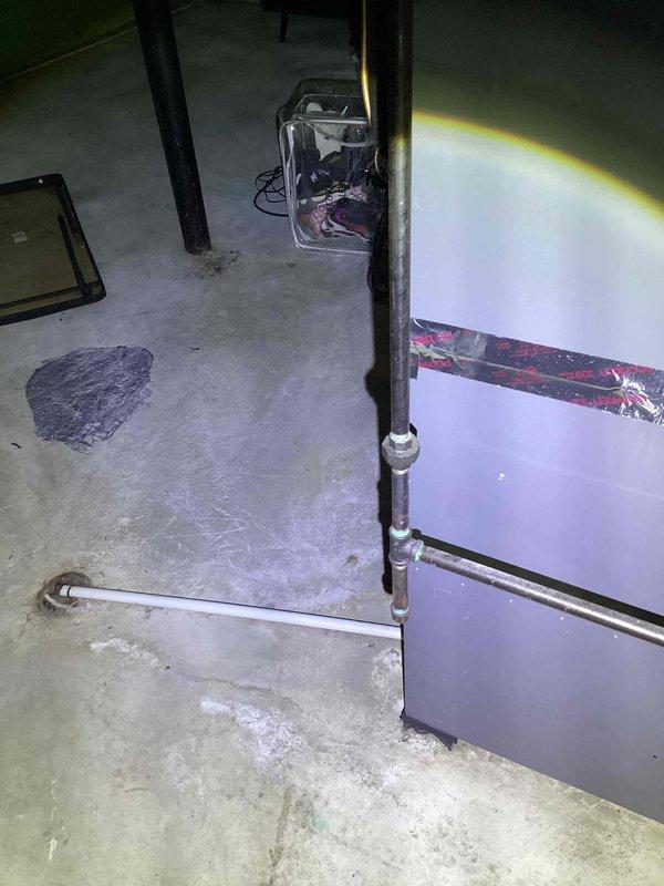 Responded to customer complaint of air conditioning system not cooling properly. Upon inspection, diagnosed low refrigerant charge in R-410A system. Evaluated existing equipment in basement utility area and outdoor unit in backyard to determine system age and condition for replacement estimate. Documented current installation configuration including indoor air handler, refrigerant lines, and electrical connections. Provided comprehensive replacement estimate options based on findings.